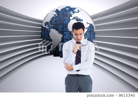 Composite image of unsmiling businessman holding glasses 9613340