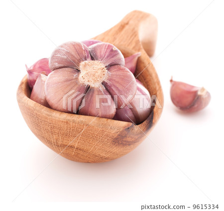 Garlic cloves in wooden bowl isolated on white background Garlic cloves in wooden bowl isolated on white background 9615334