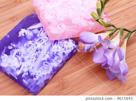 Lilac and pink soap on wooden background in a spa composition Lilac and pink soap on wooden background in a spa composition 9615645
