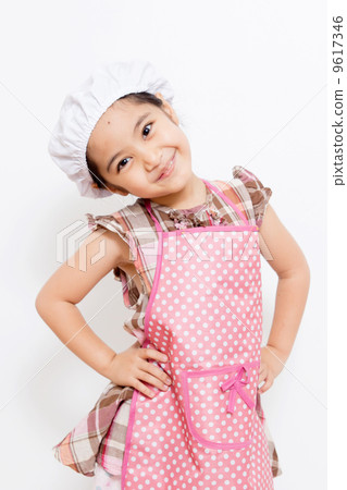 Happy little Asian cute chef wearing pink apron Happy little Asian cute chef wearing pink apron 9617346