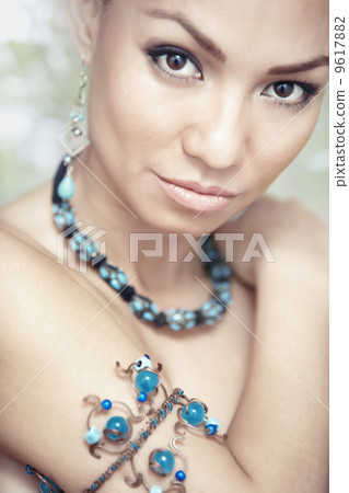 Woman with blue jewelry 9617882