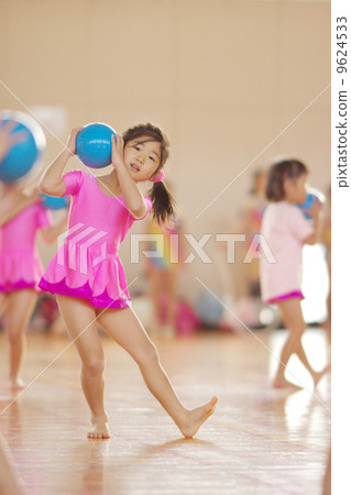 Girls practicing rhythmic gymnastics 9624533