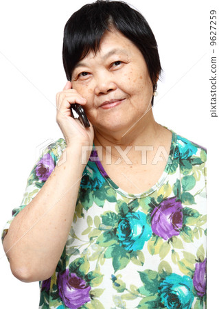 Old senior woman using the internet with her mobile phone 9627259