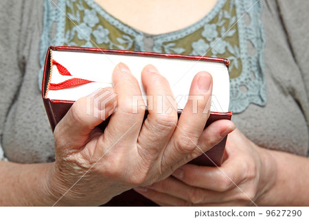 Human hands holding a book. Human hands holding a book. 9627290
