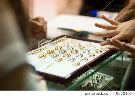 Woman trying wedding rings at a jeweller Woman trying wedding rings at a jeweller 9628105