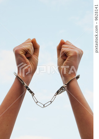 Handcuffed woman's hands 9628141