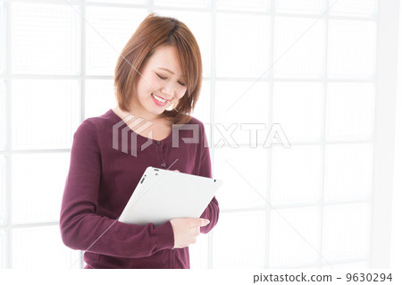 A woman watching a tablet 9630294