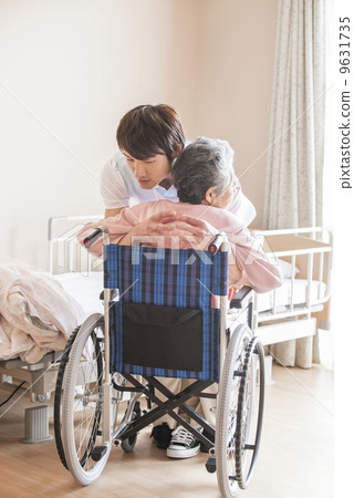 Male caregiver assisting transfer and older women Male caregiver assisting transfer and older women 9631735