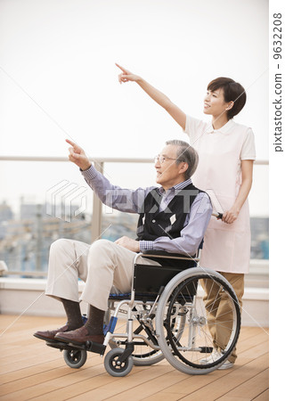 Wheelchair male and female caregiver Wheelchair male and female caregiver 9632208