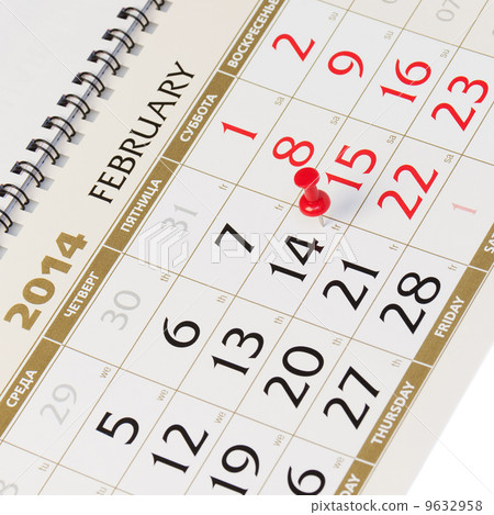 Calendar page with red thumbtack on February 14 2014. 9632958