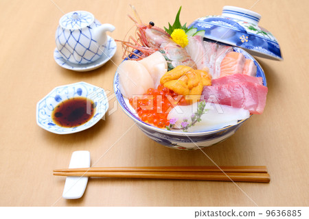 Bowl of rice topped with sashimi  9636885