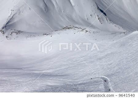 Snowboarders and skiers on slope and off-piste slope with trace Snowboarders and skiers on slope and off-piste slope with trace 9641540
