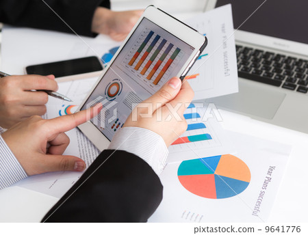 Close-up of business team using digital tablet with financial d Close-up of business team using digital tablet with financial d 9641776