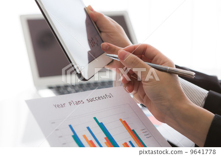 Close-up of business team using digital tablet with financial d Close-up of business team using digital tablet with financial d 9641778