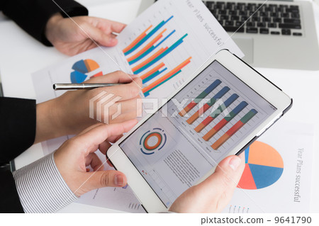 Close-up of business team using digital tablet with financial d Close-up of business team using digital tablet with financial d 9641790