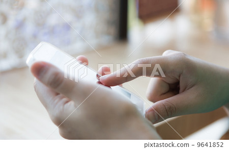 Hands holding and pointing on Smart Phone 9641852