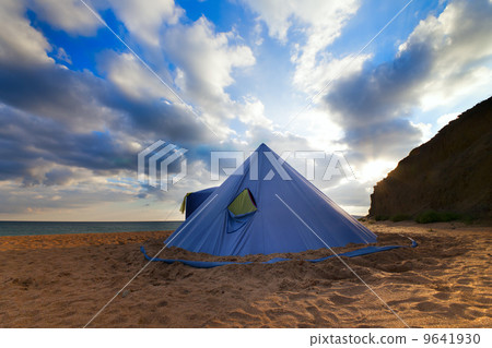 Conical tent on summer beach and blue sky with clouds Conical tent on summer beach and blue sky with clouds 9641930