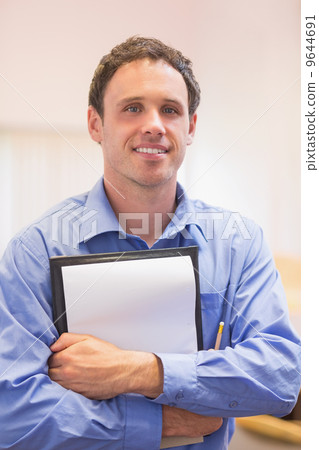 Close up portrait of an elegant male teacher with notepad Close up portrait of an elegant male teacher with notepad 9644691