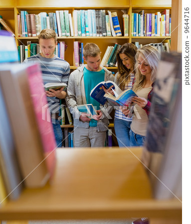 Students reading book in the college library 9644716