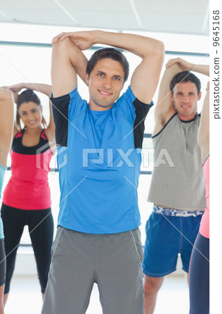 Portrait of sporty people stretching hands at yoga class Portrait of sporty people stretching hands at yoga class 9645168
