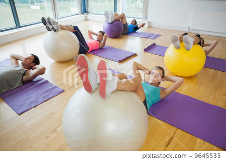 High angle view of class exercising with fitness balls High angle view of class exercising with fitness balls 9645535
