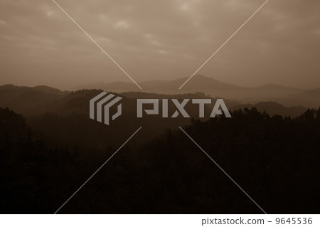 Trees and mountain range against cloudscape Trees and mountain range against cloudscape 9645536