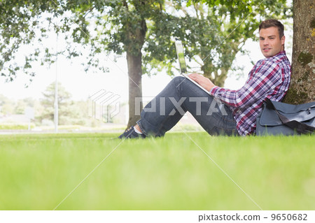 Happy student using his laptop to study outside 9650682