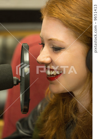 Pretty redhead student presenting a radio show Pretty redhead student presenting a radio show 9651413