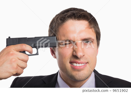 Close-up of a businessman holding a gun to head 9651902