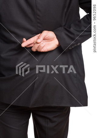 Mid section of a businessman with crossed fingers 9652098