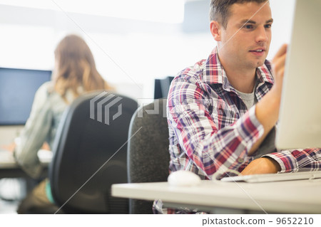 Happy student working in the computer room 9652210