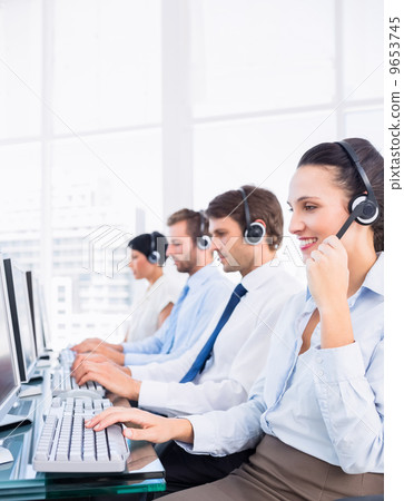 Business colleagues with headsets using computers 9653745