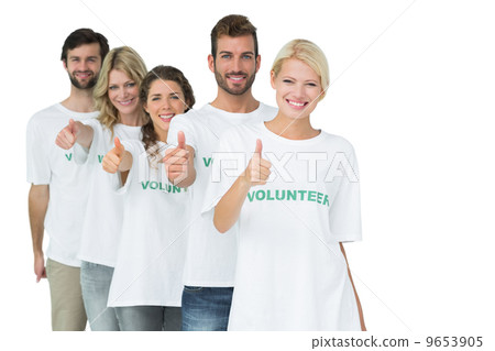 Group portrait of happy volunteers gesturing thumbs up 9653905