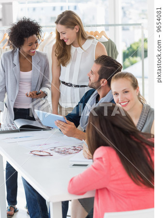 Fashion designers discussing designs Fashion designers discussing designs 9654081