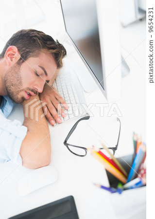 Male artist with head resting on keyboard Male artist with head resting on keyboard 9654231