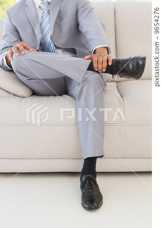 Businessman on couch Businessman on couch 9654276