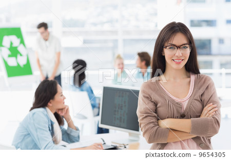 Female artist with colleagues in the background at office Female artist with colleagues in the background at office 9654305