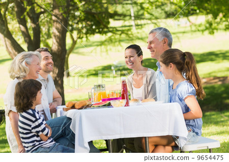 Extended family dining at outdoor table 9654475