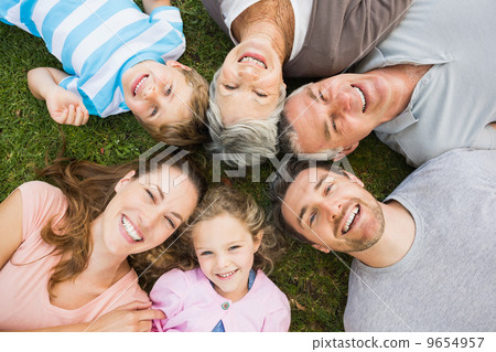 Extended family lying in circle at park Extended family lying in circle at park 9654957