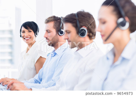Business colleagues with headsets in a row 9654973