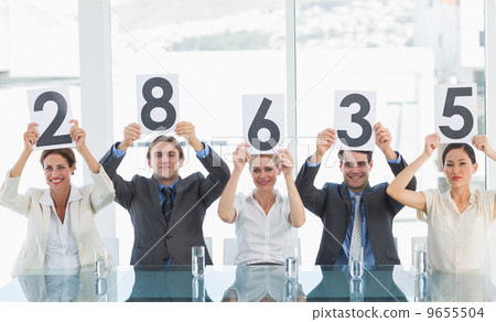 Group of panel judges holding score signs 9655504