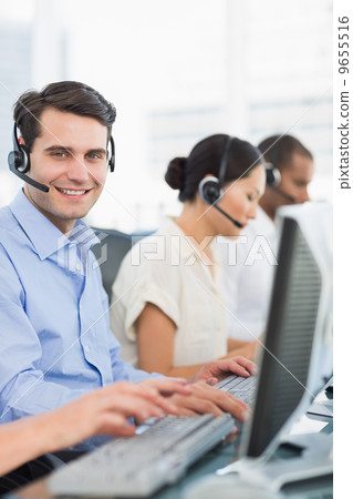 Business colleagues with headsets using computers Business colleagues with headsets using computers 9655516