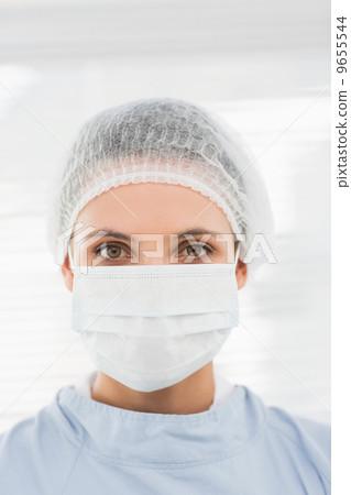 Female surgeon wearing surgical cap and mask 9655544