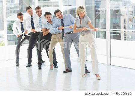 Group of business people pulling rope in office Group of business people pulling rope in office 9655585