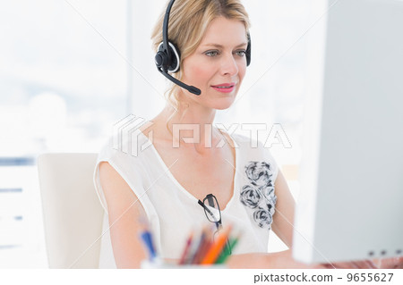 Casual woman with headset using computer 9655627