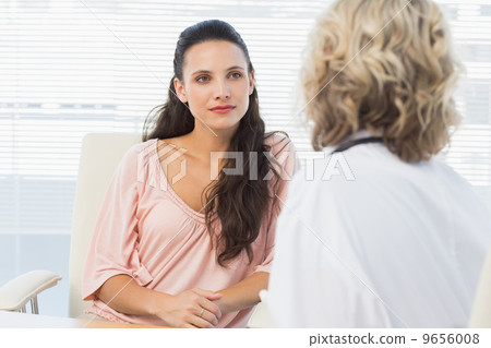 Female patient listening to doctor with concentration in medical Female patient listening to doctor with concentration in medical 9656008