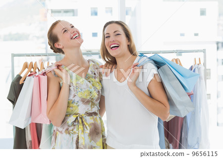 Cheerful women with shopping bags in the clothes store 9656115