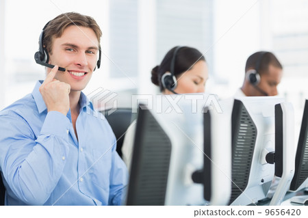 Business colleagues with headsets using computers Business colleagues with headsets using computers 9656420