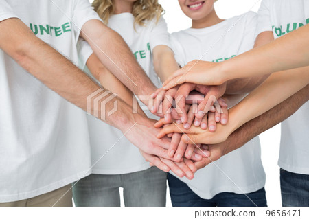 Mid section of volunteers with hands together 9656471