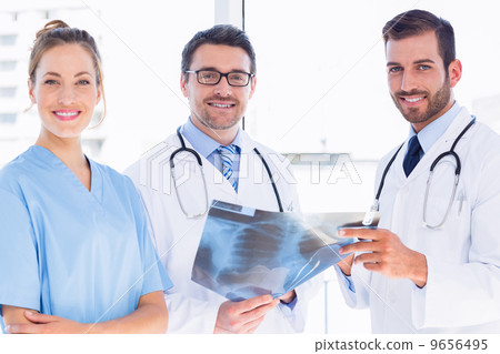 Portrait of doctors with x-ray report at medical office Portrait of doctors with x-ray report at medical office 9656495